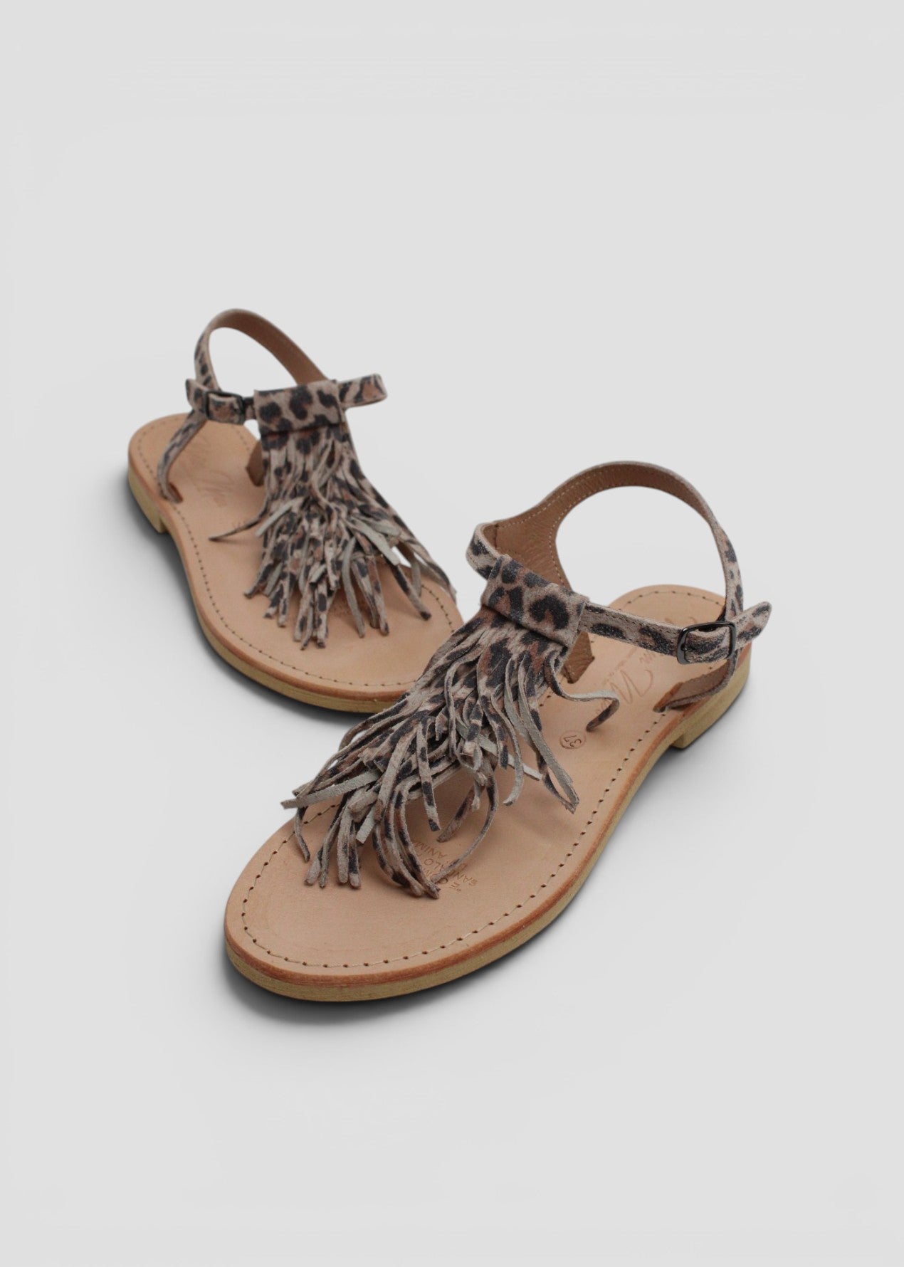ARIEL – SANDALO INFRADITO IN SUEDE STAMPA MACULATA CON FRANGE E CINTURINO ALLA CAVIGLIA