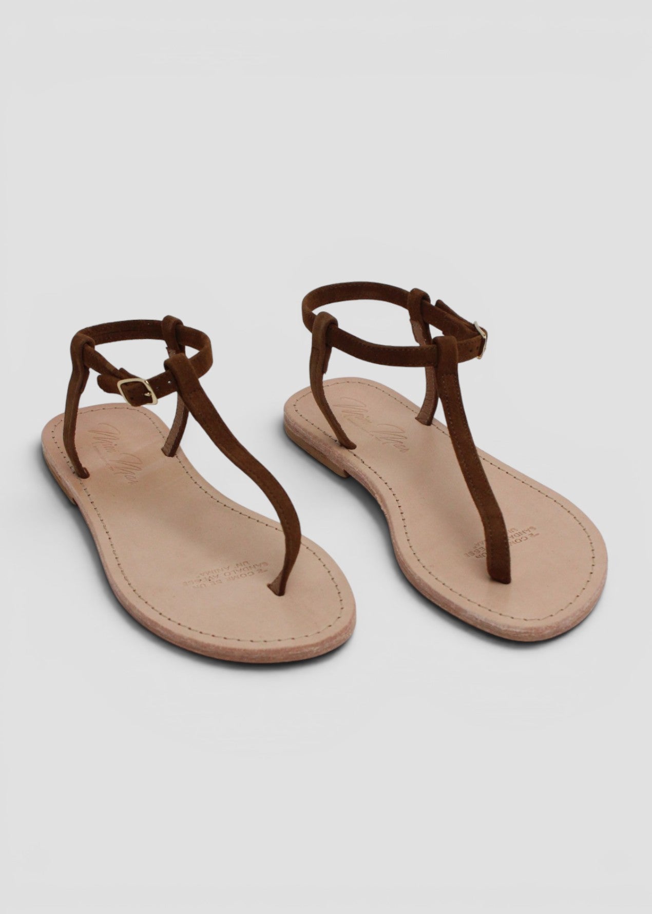 INDRID – SANDALO INFRADITO IN SUEDE NOCCIOLA CON CINTURINO ALLA CAVIGLIA